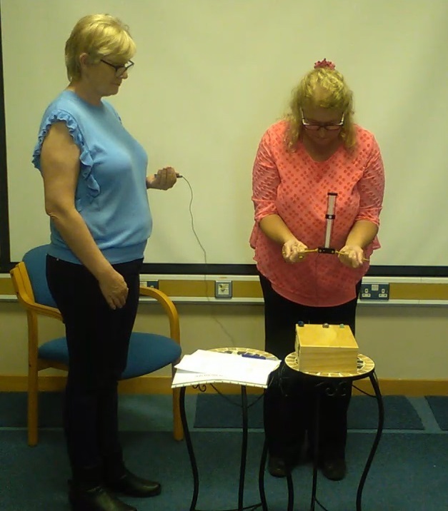 Anne-Marie demonstrating how to screen crystals with a Lecher Antenna Learn Dowsing